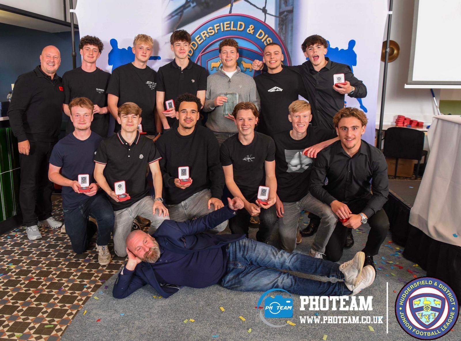 Players holding their medals at the league awards night